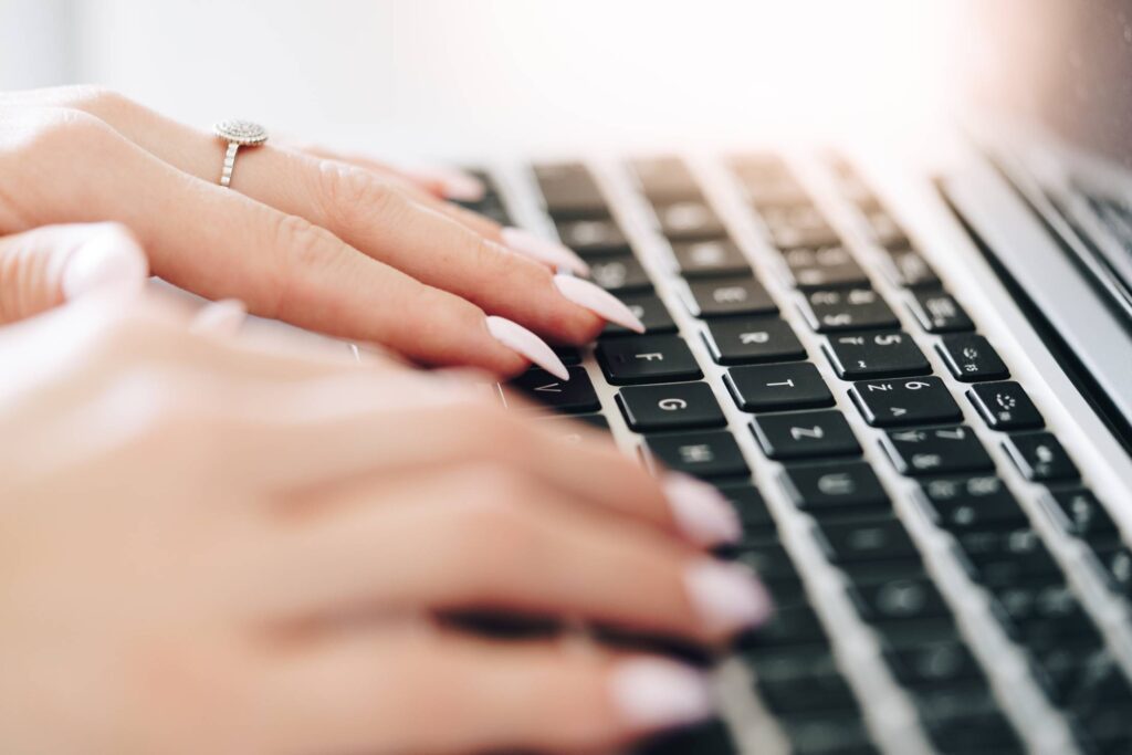 Woman Entrepreneur Working on Laptop Close Up Free Photo