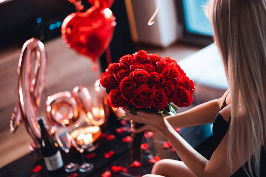 Woman Holding a Bouquet of Red Roses on a Valentine’s Day Romantic Date Free Photo