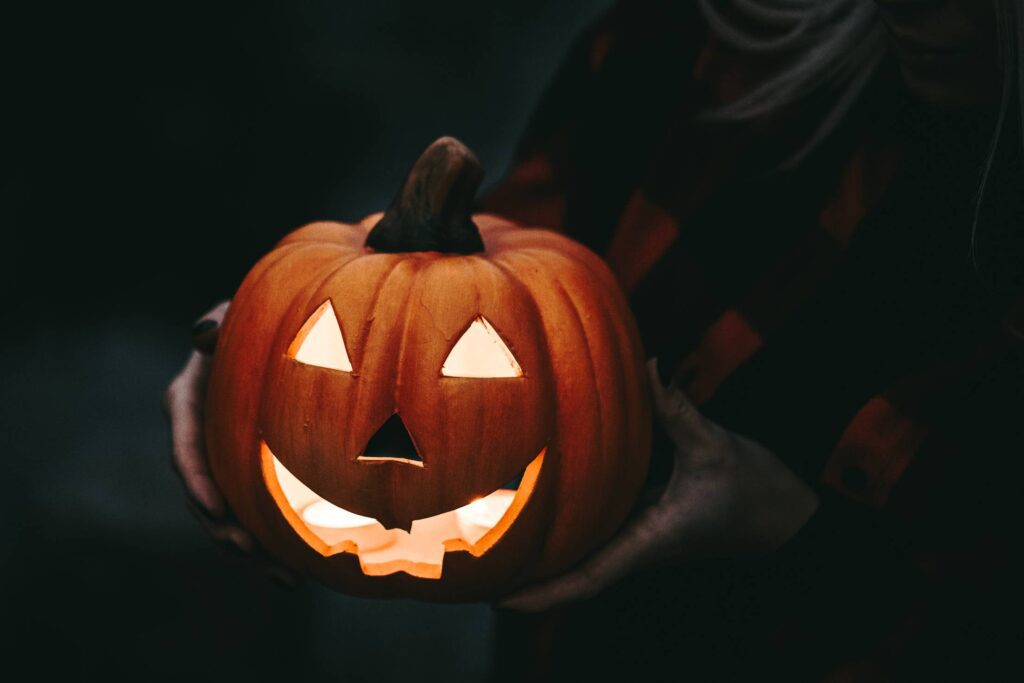 Woman Holding a Carved Halloween Pumpkin Free Photo