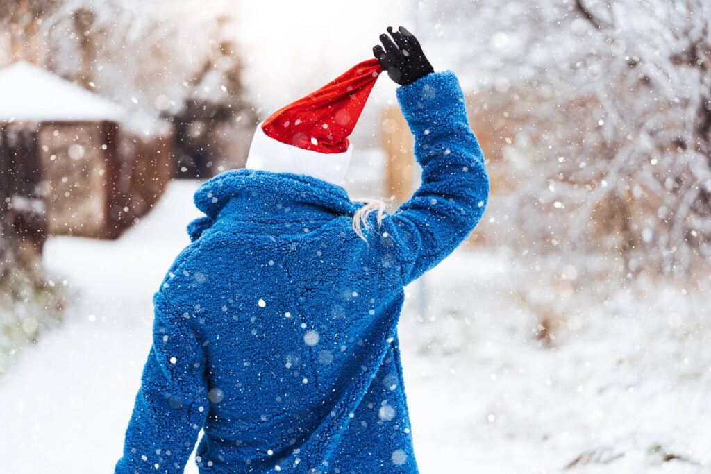 Woman Holding a Christmas Hat Free Photo