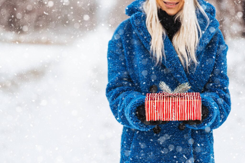 Woman Holding a Christmas Present Free Photo