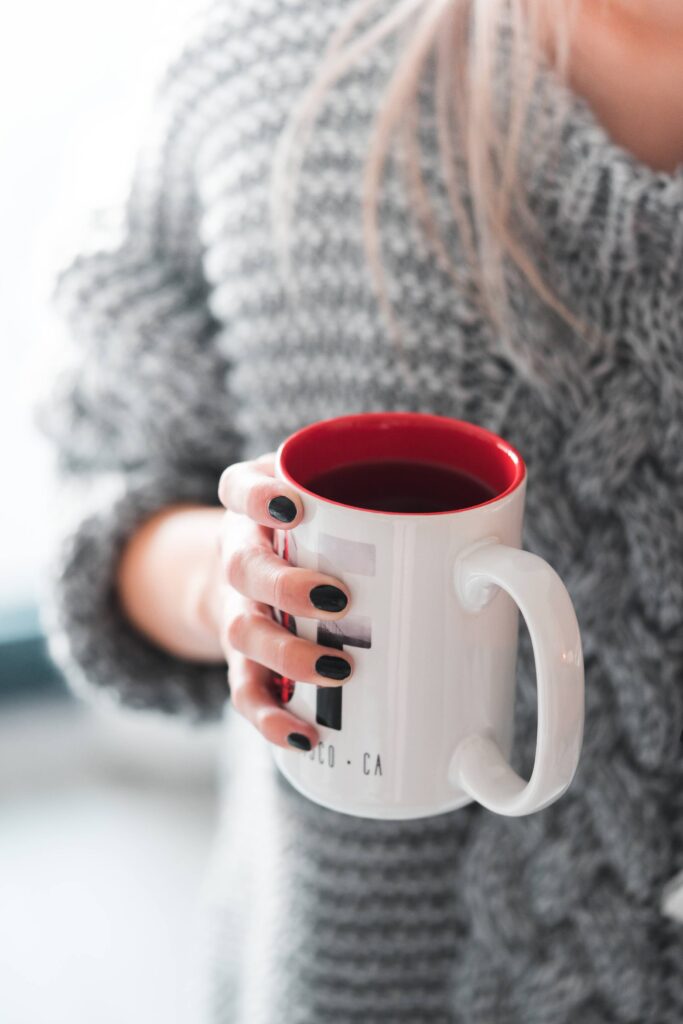 Woman Holding a Cup of Tea Free Photo