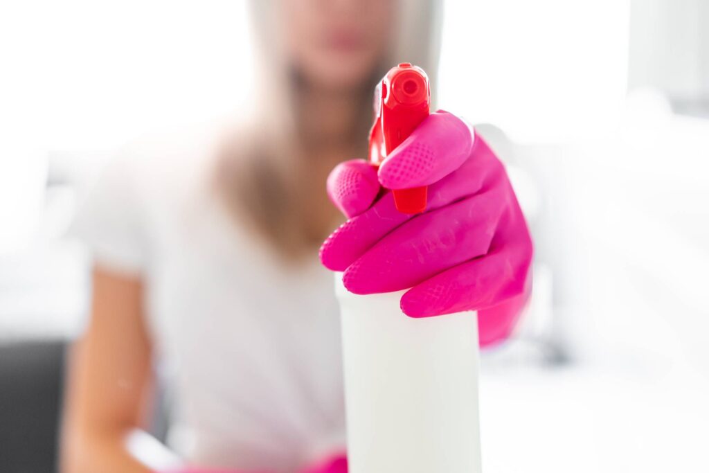 Woman Holding a Detergent Spray Bottle Free Photo