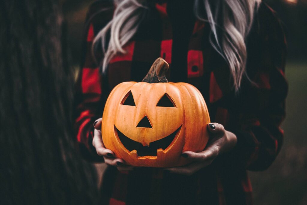 Woman Holding a Halloween Pumpkin Free Photo