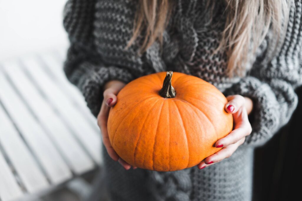 Woman Holding a Pumpkin Free Photo