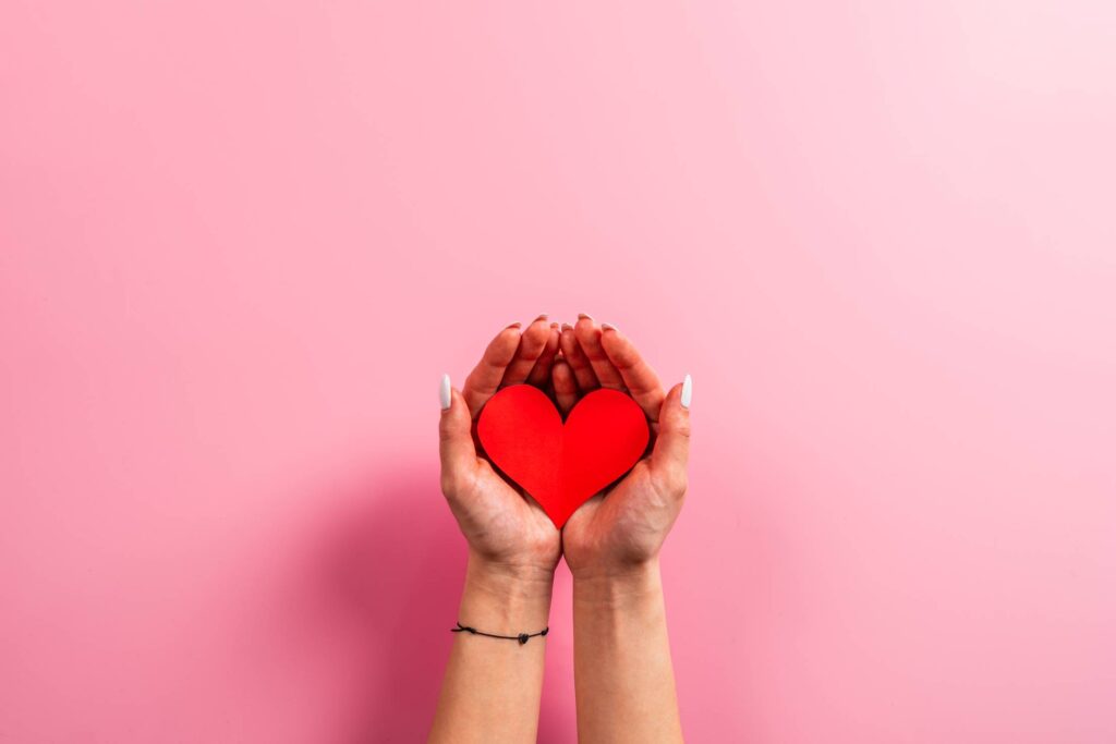 Woman Holding a Red Heart in Her Hands Free Photo