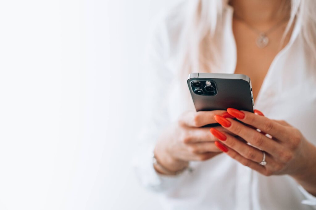 Woman Holding a Smartphone Free Photo