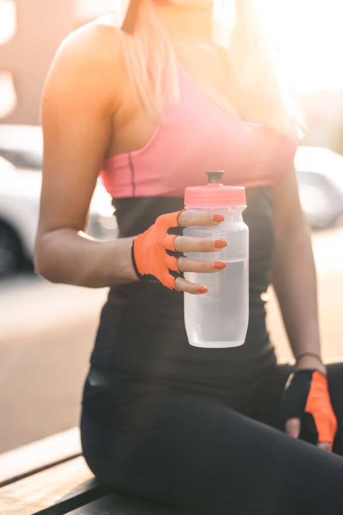 Woman Holding a Sports Bottle Free Photo