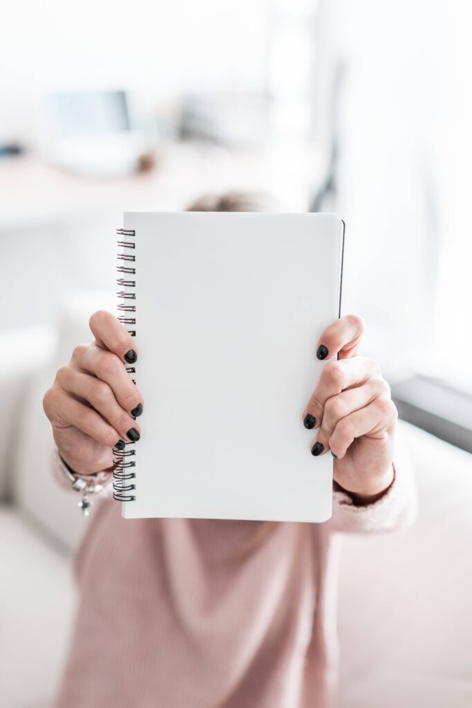 Woman Holding Blank Notebook Free Photo