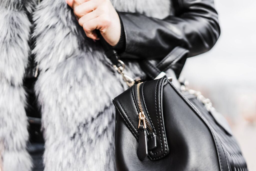 Woman Holding Her Black Leather Bag Close Up Free Photo