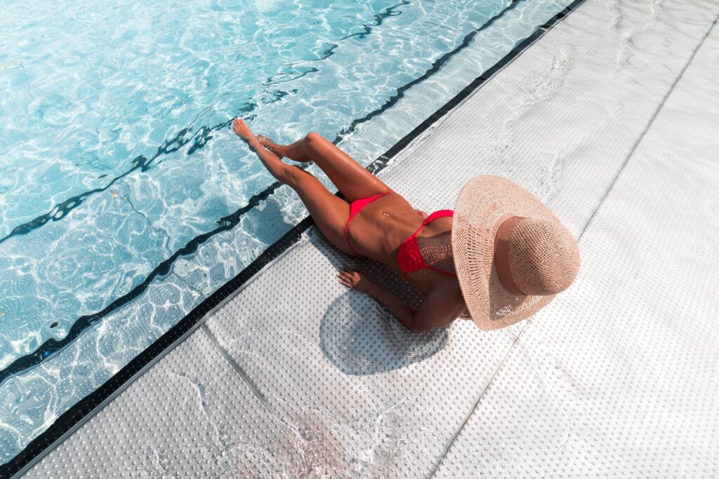 Woman in Bikini Sunbathing at The Pool Free Photo