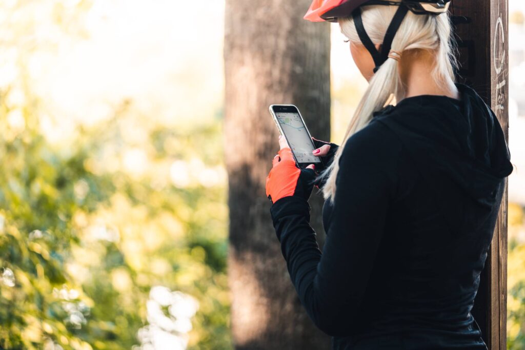 Woman in Cycling Clothes Looking at The Map on The Phone Free Photo