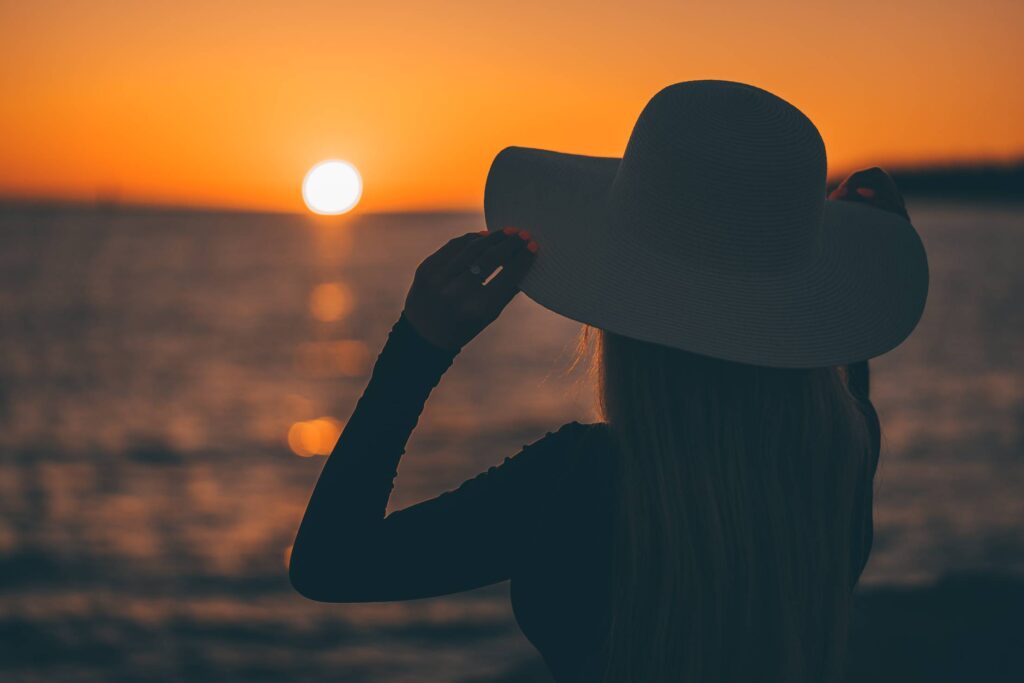 Woman in White Hat Looking at Croatian Sunset over The Sea Free Photo