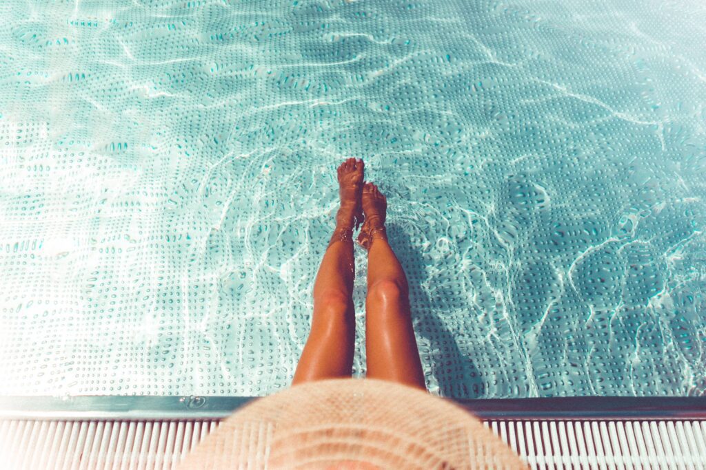 Woman Legs in Swimming Pool Free Photo