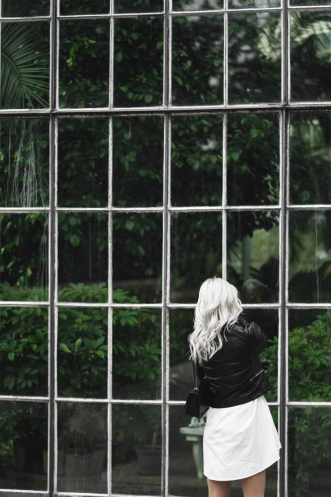 Woman Looking Through Old Windows of The Botanical Garden Free Photo