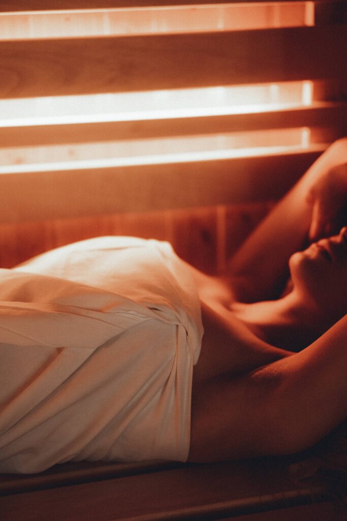 Woman Lying in a Finnish Sauna Close Up Vertical Free Photo