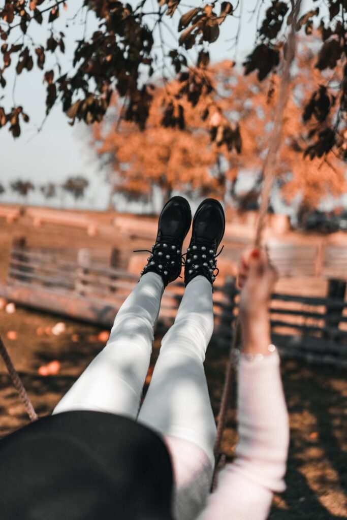 Woman on a Swing in an Autumn Nature Free Photo