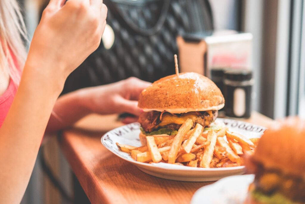 Woman Preparing to Eat Big Bacon Burger Free Photo