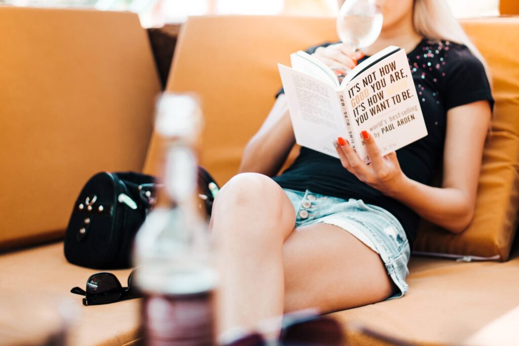 Woman Reading a Book in a Café Free Photo