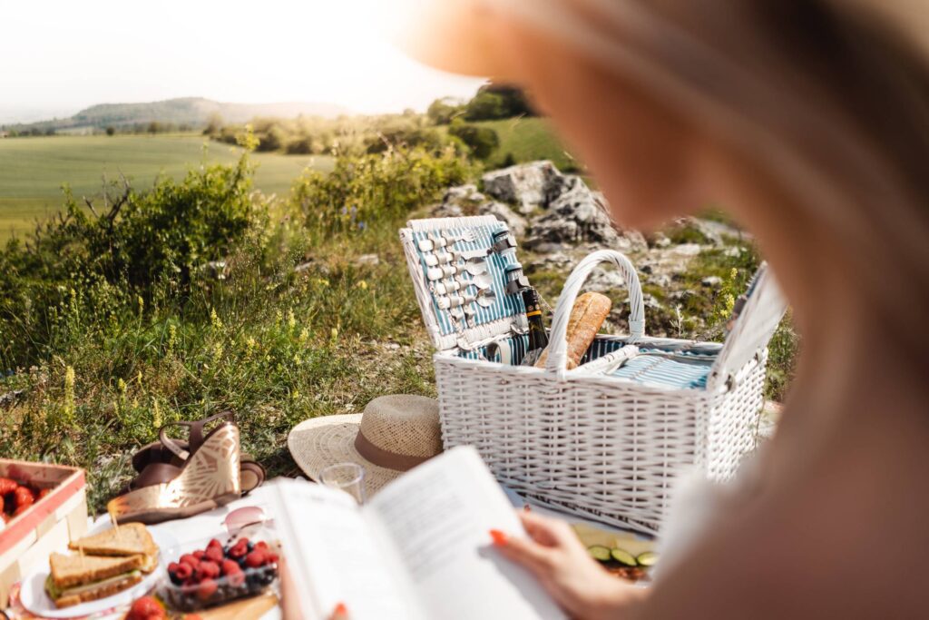 Woman Reading a Book on Picnic Free Photo