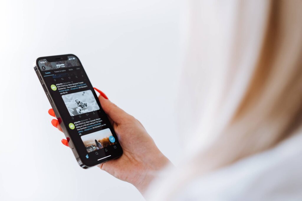 Woman Reading Twitter on a New Smartphone Free Photo