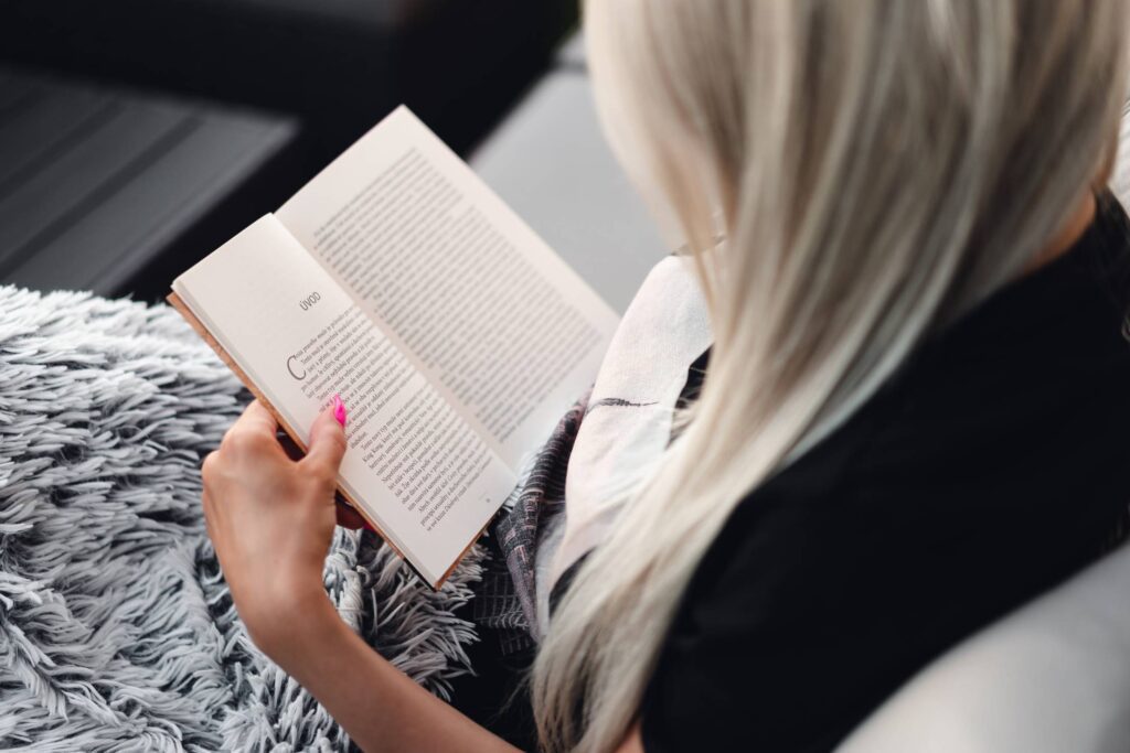 Woman Relaxing and Reading a Book Free Photo