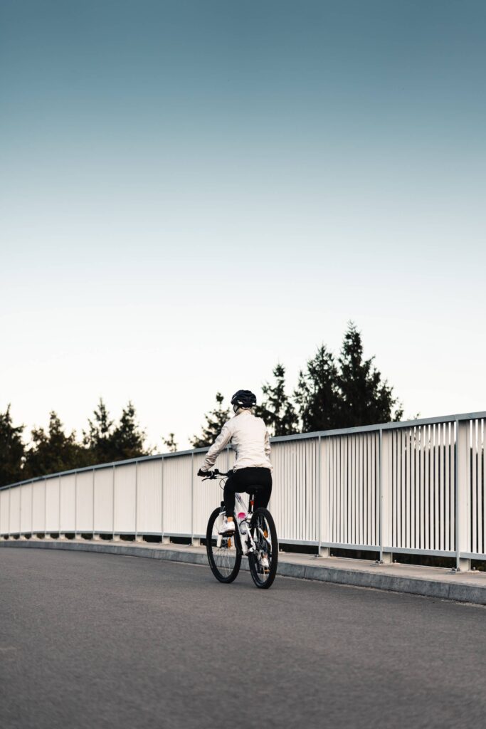 Woman Riding a Bicycle and Wearing a Helmet Free Photo