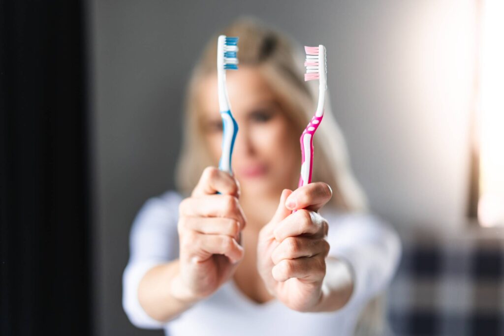 Woman Showing Toothbrushes Free Photo