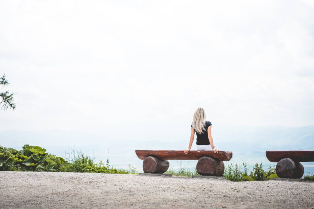 Woman Sitting on a Bench Place for Text Free Photo