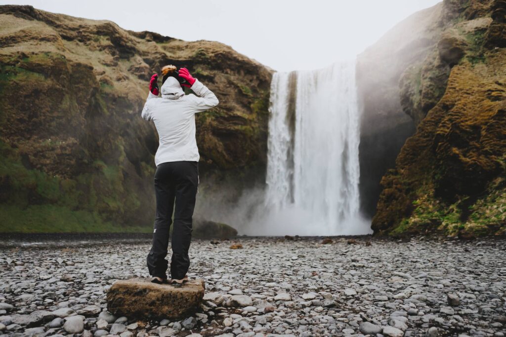 Woman Standing at Skógafoss Waterfall Free Photo