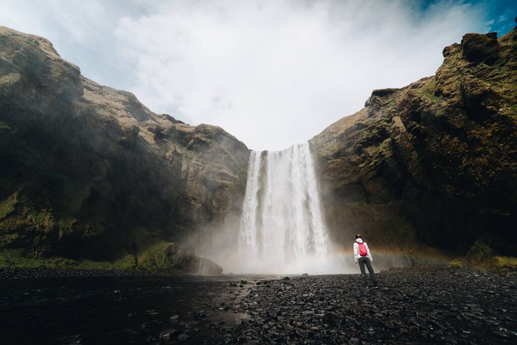 Woman Standing Near Skógafoss Waterfall Free Photo