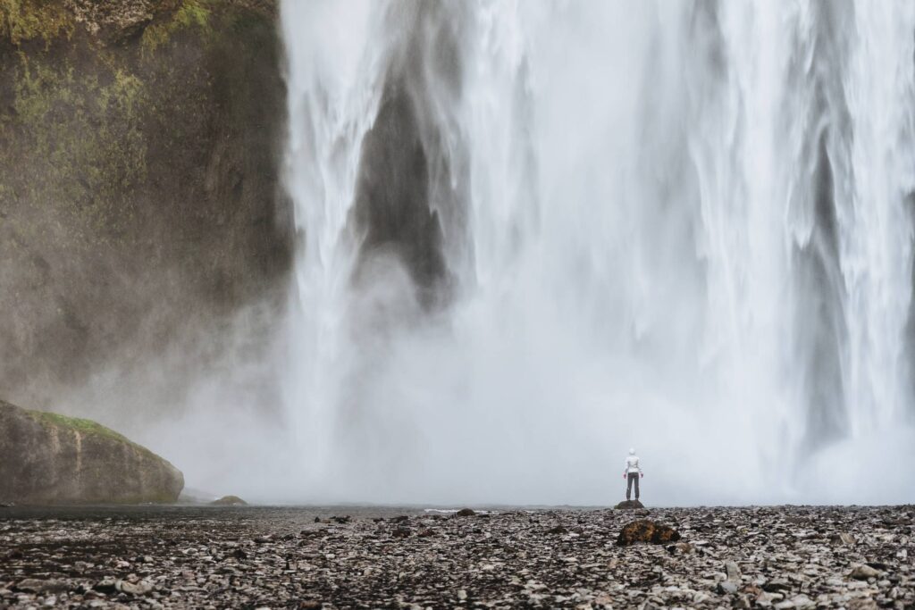 Woman Standing Near Waterfalls Free Photo