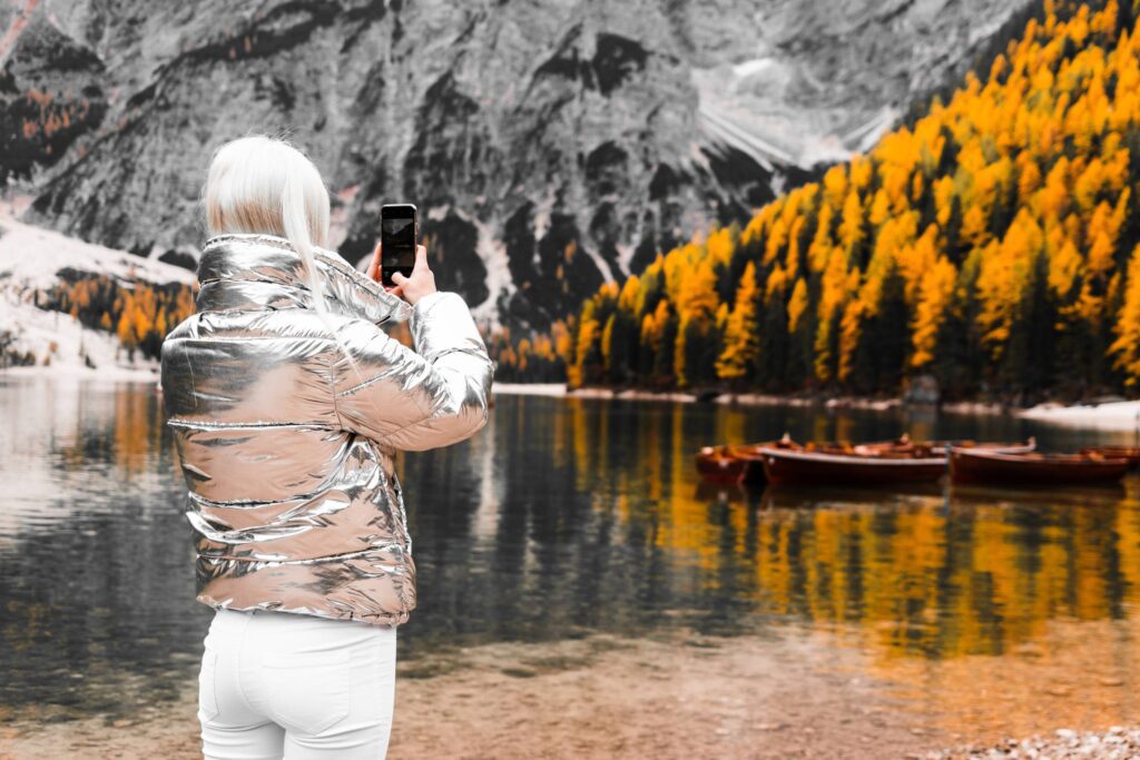 Woman Taking a Photo of Braies Lake in Italy Free Photo