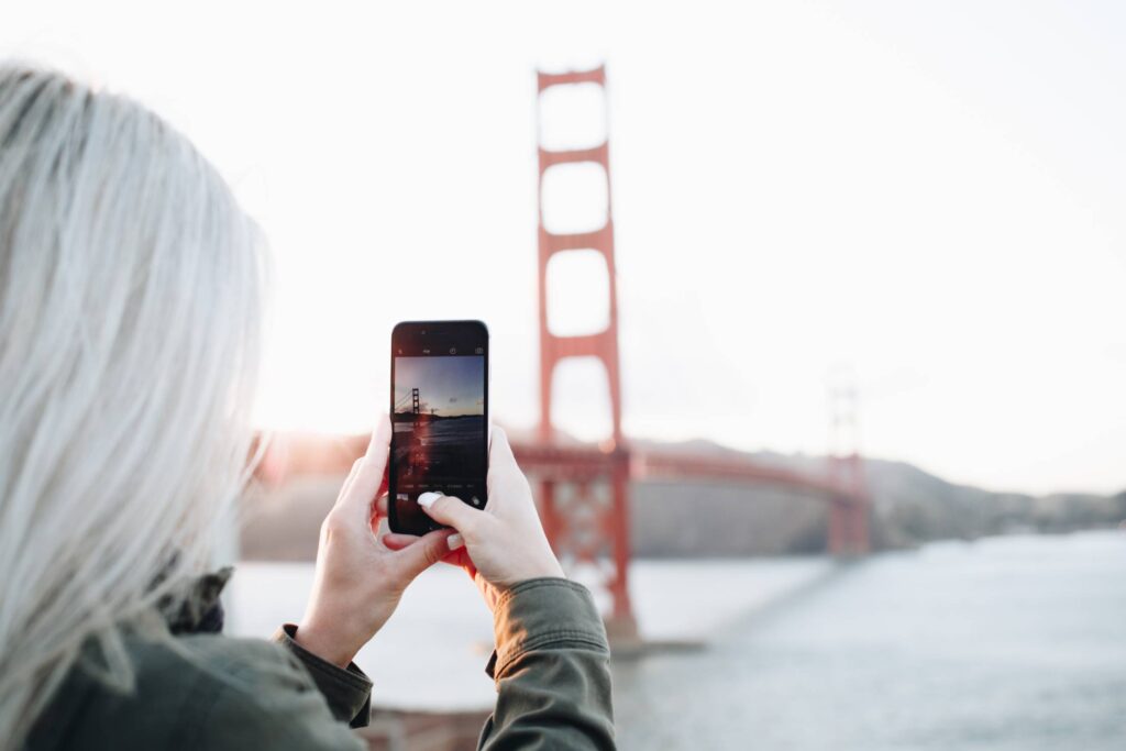 Woman Taking a Photo of The Golden Gate Bridge Free Photo