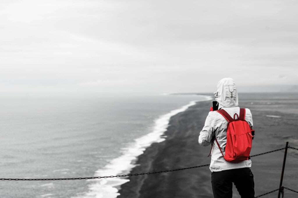 Woman Taking a Picture of a Black Beach in Iceland Free Photo