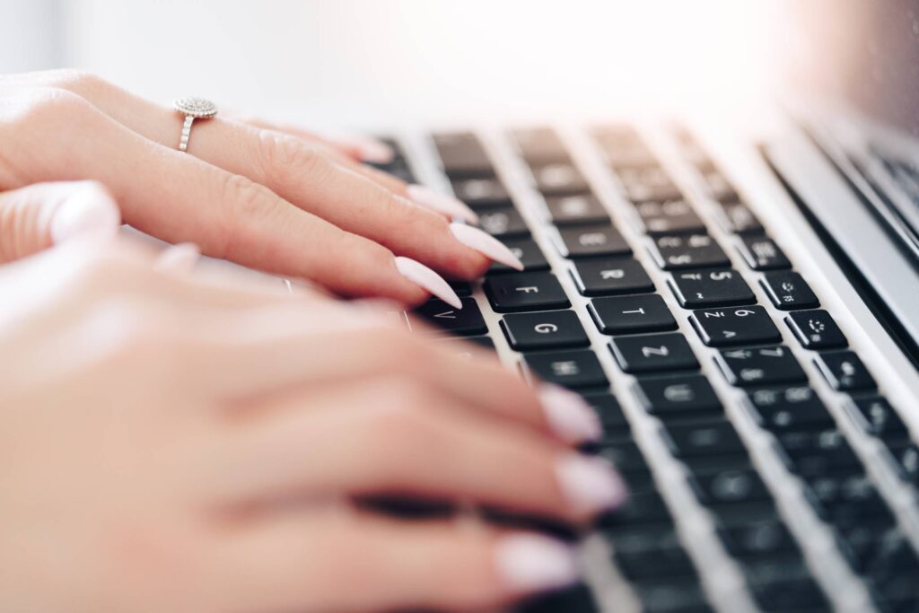 Woman Typing on a Laptop Free Photo