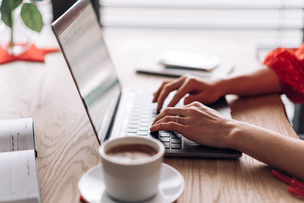 Woman Typing on Her Laptop at Home Free Photo