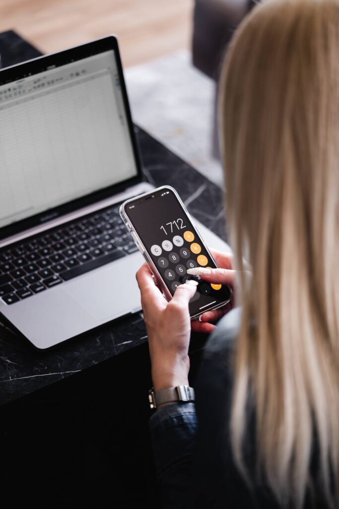 Woman Using a Calculator on Her Smartphone Free Photo