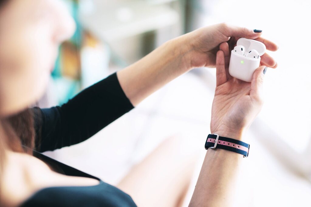 Woman Using Her AirPods Free Photo