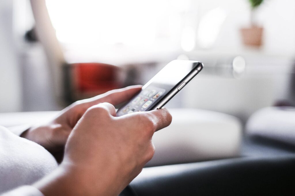 Woman Using Her iPhone At Home Office Free Photo