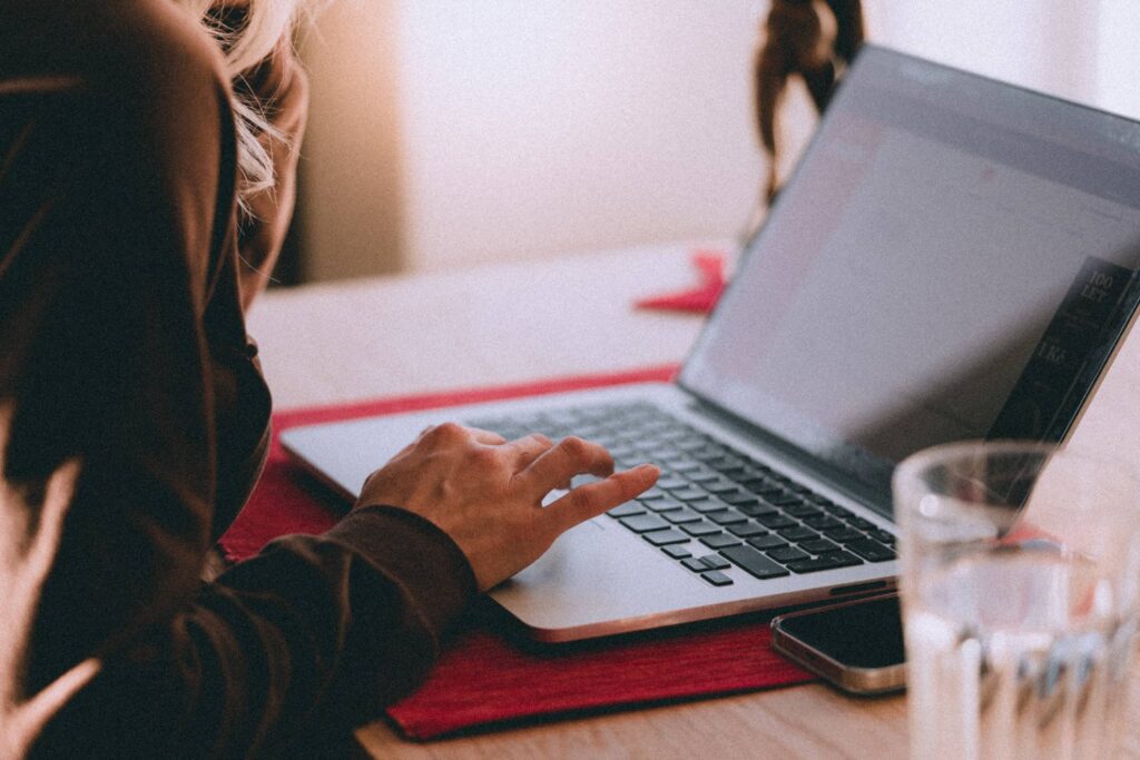 Woman Using Her Laptop Comfortably at Home Free Photo