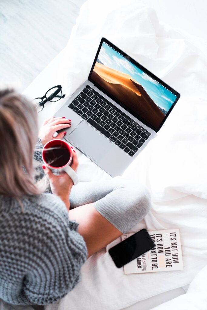 Woman Using Her Laptop in Bed Free Photo