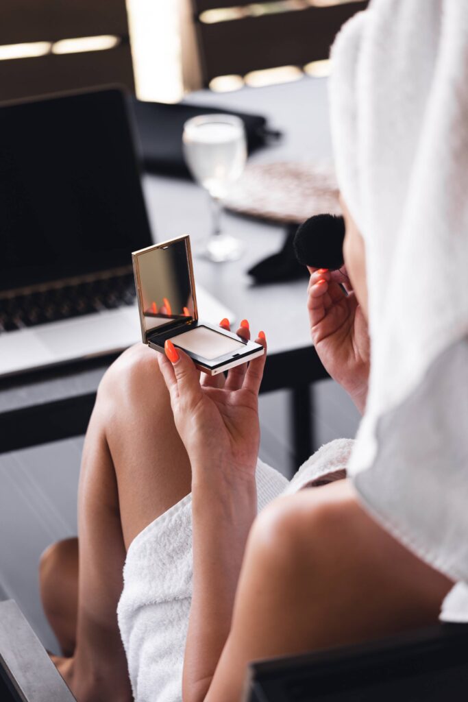 Woman Using Make-up Powder and Enjoying Morning on Terrace Free Photo