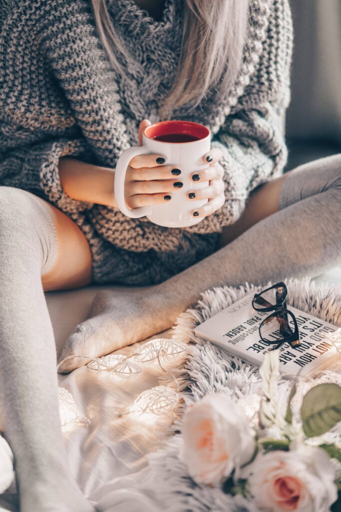 Woman Wearing Knitted Sweater Relaxing in Bed Free Photo