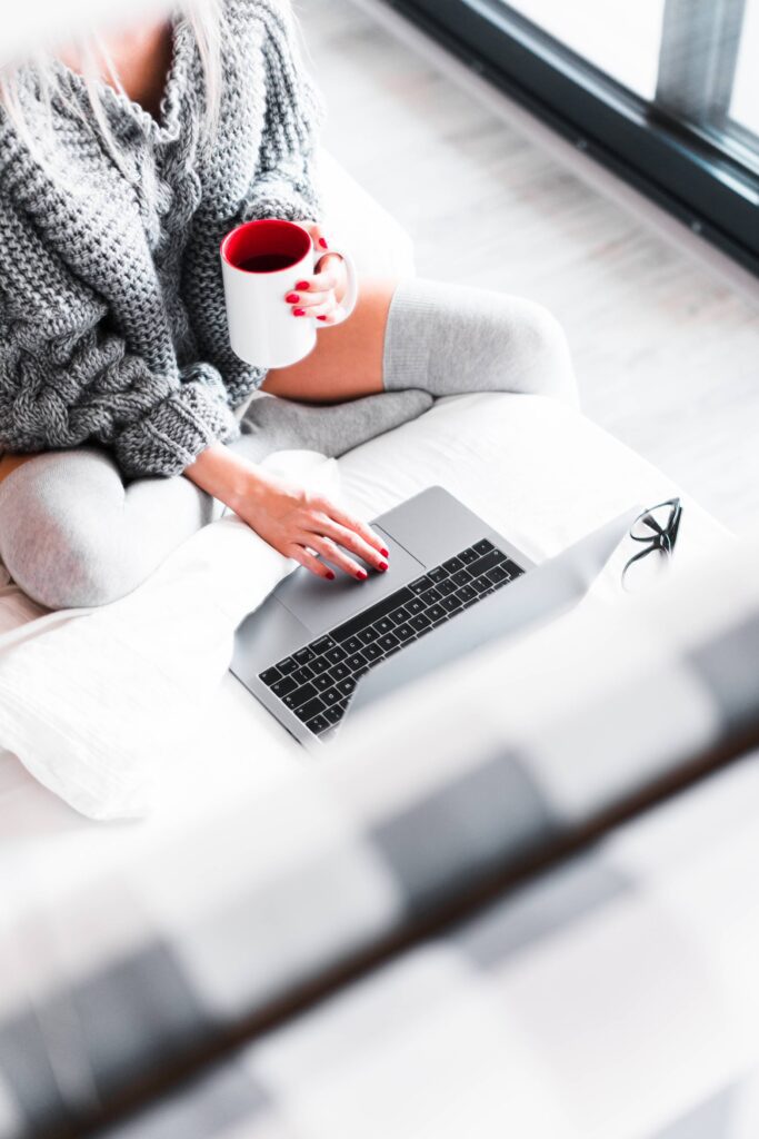 Woman Working from Her Bed with Laptop Free Photo