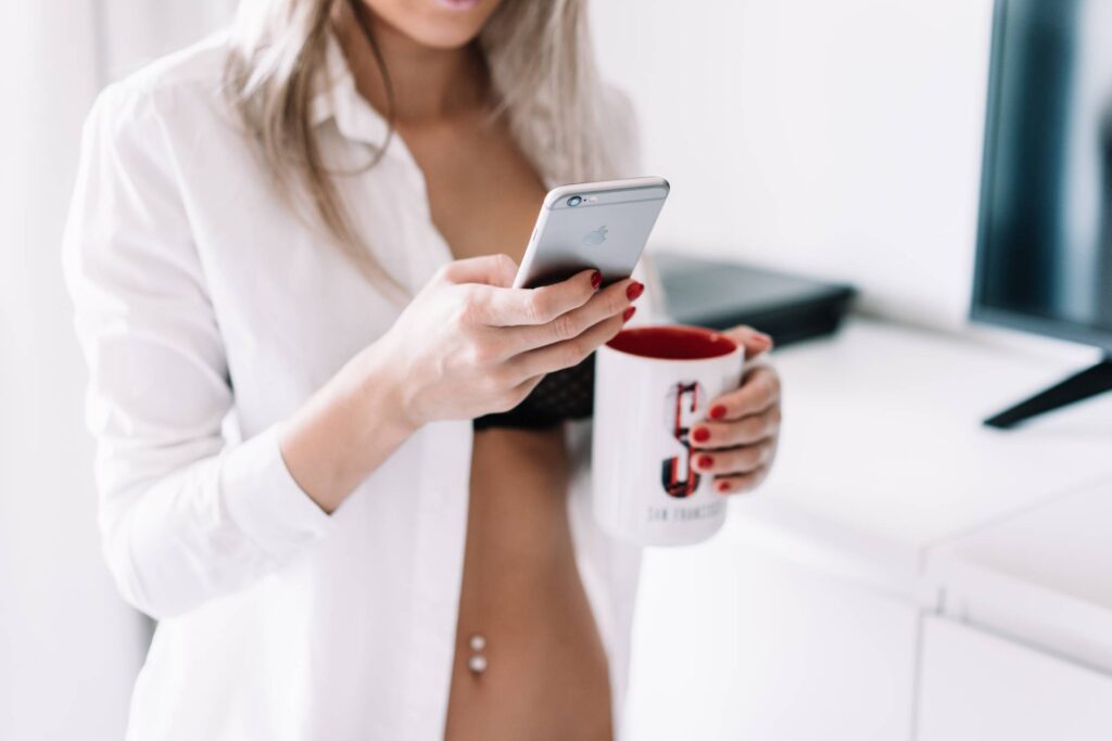 Woman Working on iPhone from Home Free Photo