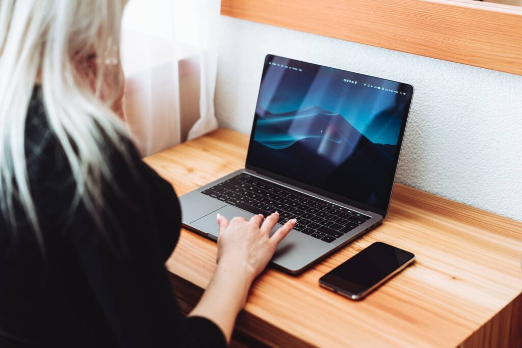 Woman Working on Modern Laptop and Smartphone Free Photo