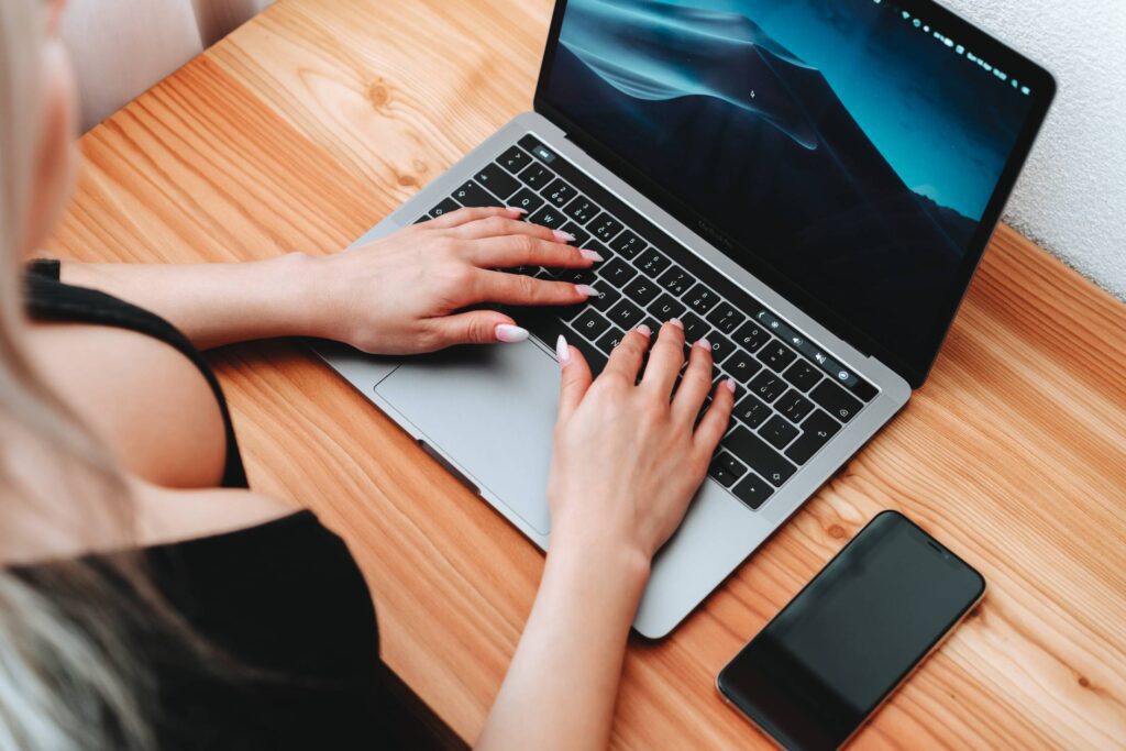 Woman Writes on MacBook Free Photo