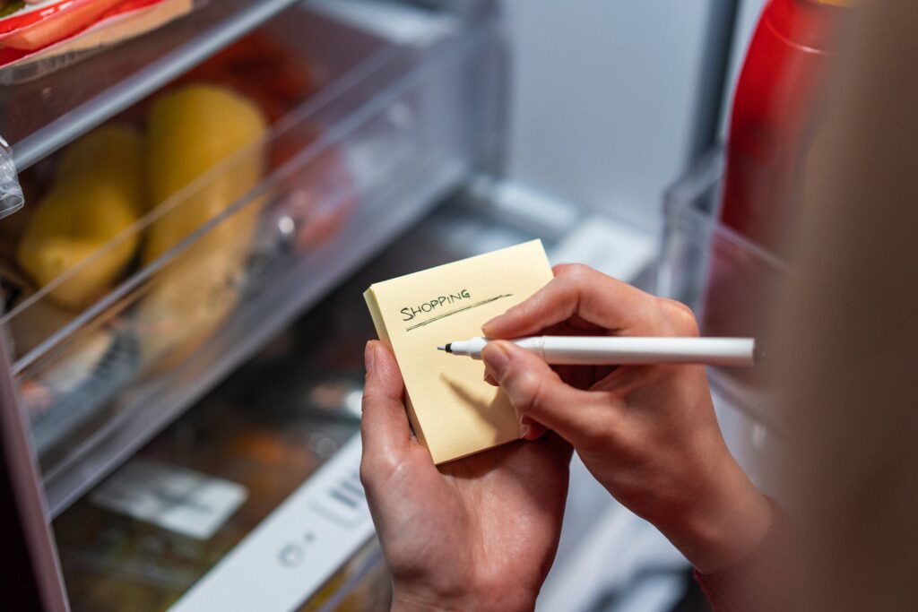 Woman Writing a Grocery Shopping List Free Photo