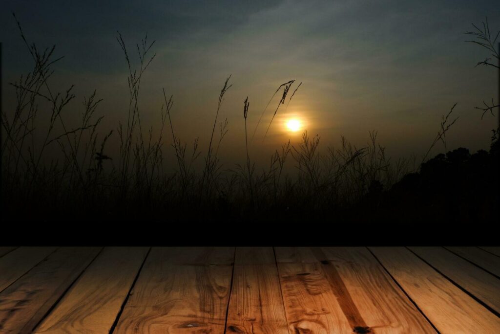 Wood board above empty table on sunset background. Brown wooden table can be used mock-up for display of montage products or key visual layout designs Stock Free